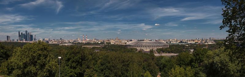 View of cityscape against cloudy sky