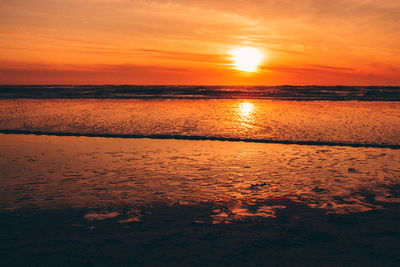 Scenic view of sea against orange sky