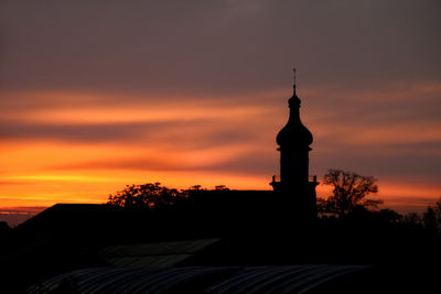 Silhouette of building against orange sky church 