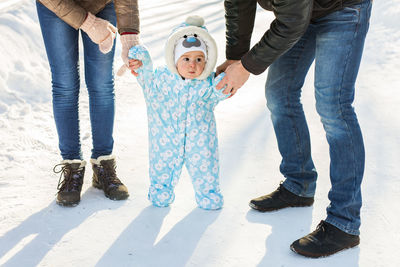 Full length of father and son standing on snow