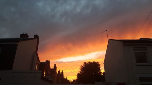 Low angle view of silhouette buildings against sky during sunset