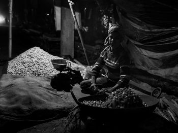 High angle view of man selling peanut at market