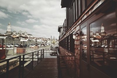 Bridge over harbor against sky in city