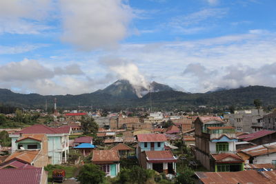 Houses in town against sky