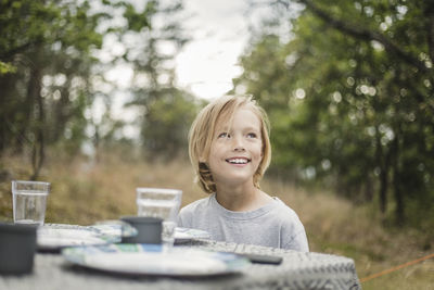 Portrait of smiling boy against trees