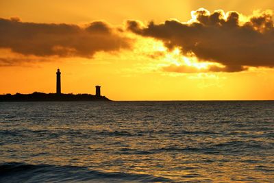 Scenic view of sea against orange sky