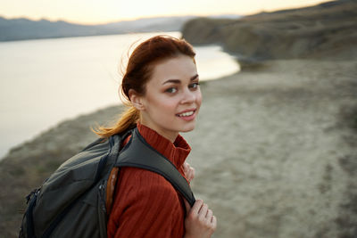 Portrait of smiling young woman standing outdoors