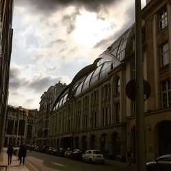 Buildings against cloudy sky