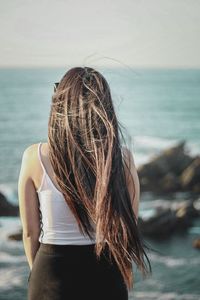 Rear view of woman standing on beach