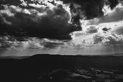 Scenic view of mountain against dramatic sky