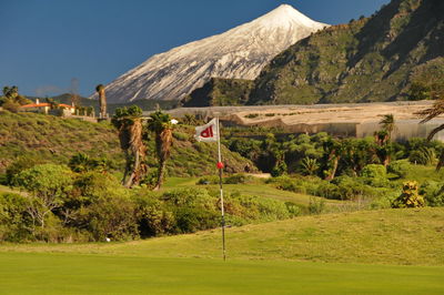 Scenic view of golf course against sky