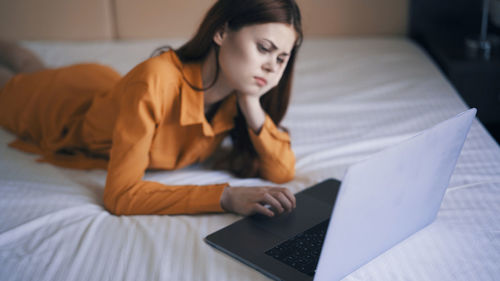 Young woman using laptop at home