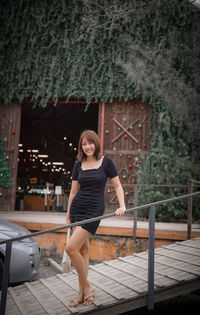 Full length of young woman sitting on staircase