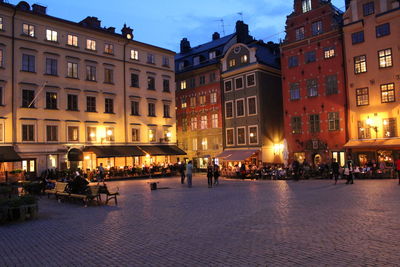 Illuminated buildings in city at dusk