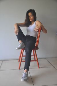 Portrait of young woman sitting on chair