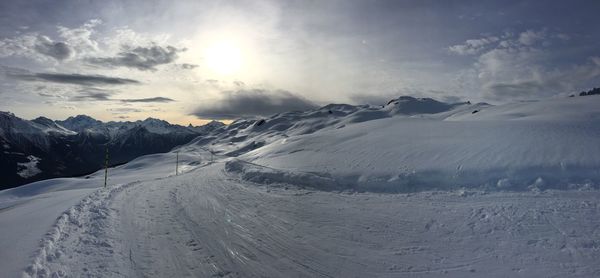 Scenic view of snow covered mountains against sky