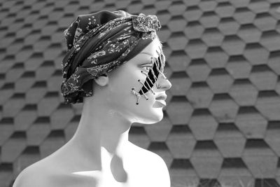 Female model with her hair covered in front of the wall