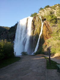 Scenic view of waterfall against clear sky