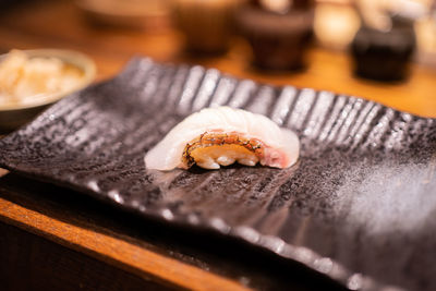 Madai nigiri sushi on black stone slate background