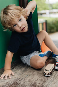 Portrait of boy sitting on floor