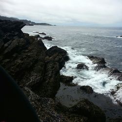 Scenic view of sea against cloudy sky