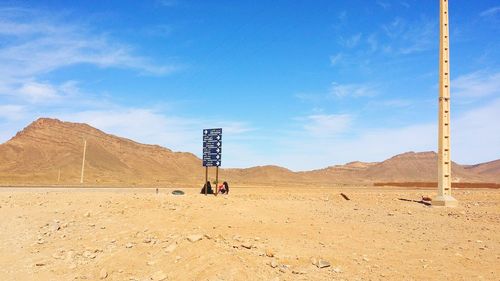 Scenic view of desert against blue sky