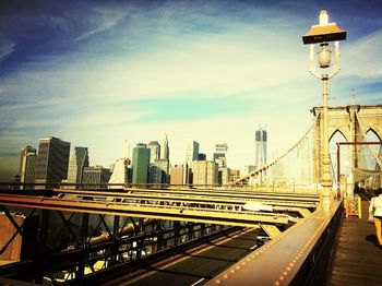 Bridge over river against cloudy sky