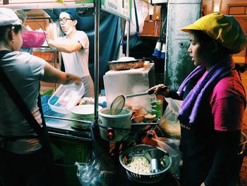 People working at market stall