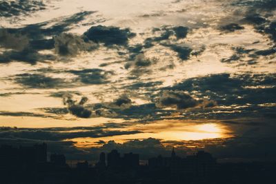 Silhouette cityscape against sky during sunset