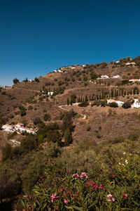 Scenic view of mountains against clear blue sky