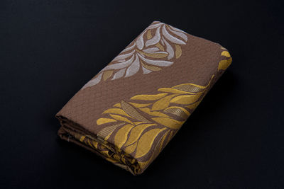 High angle view of carving on table against black background