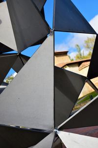 Low angle view of glass building against sky