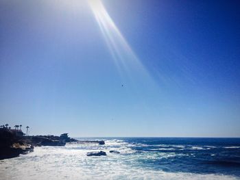 Scenic view of sea against clear blue sky