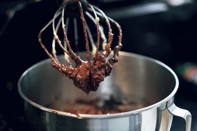 Close-up of wire whisk over container