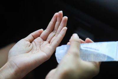 Cropped image of people hand against black background