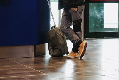 Low section of man sitting on floor