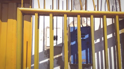 Close-up of clothes hanging on yellow wall