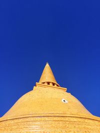 Low angle view of temple against clear blue sky