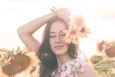 Portrait of beautiful woman with pink flower