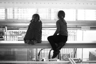 Rear view of a woman standing in the dark