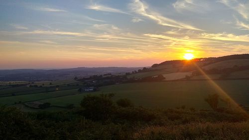 Scenic view of landscape against sky during sunset