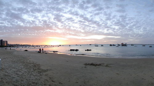 Scenic view of beach against sky during sunset