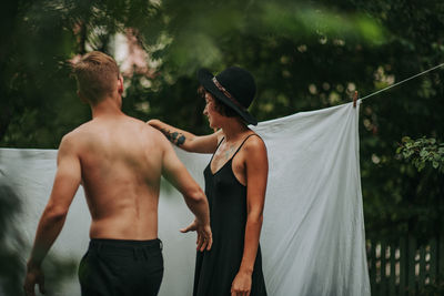 Rear view of friends standing outdoors