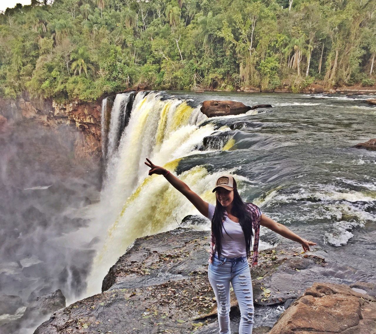 WOMAN STANDING ON ROCKS