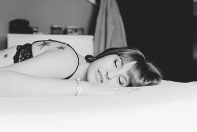 Close-up of young woman sleeping on bed at home