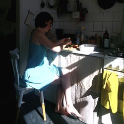 Young woman sitting on floor