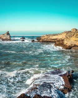 Scenic view of sea against clear blue sky