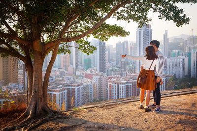 Woman showing cityscape to boyfriend