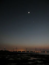 Scenic view of sea against clear sky at night