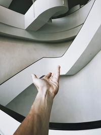 Low angle view of hand gesturing against wall